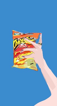 a hand holding a bag of doritos